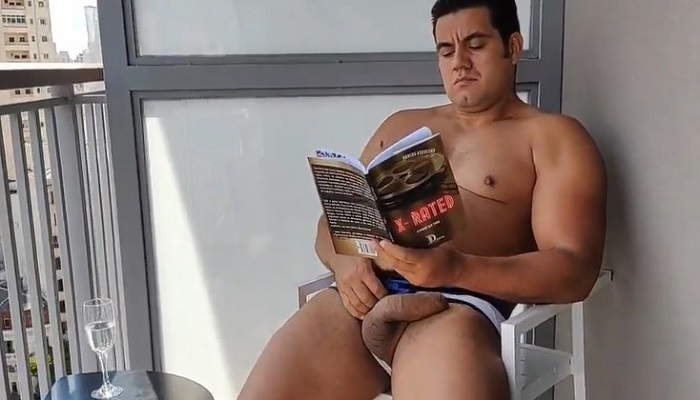 Yuri Gaucho jerks off on the balcony while reading a book