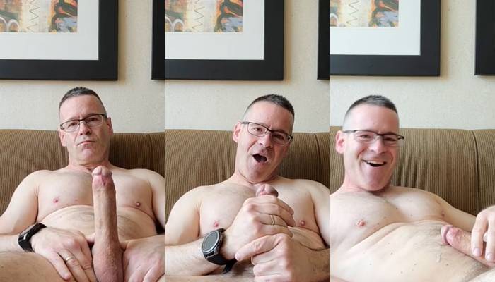 Mature guy jerks his cock on the sofa