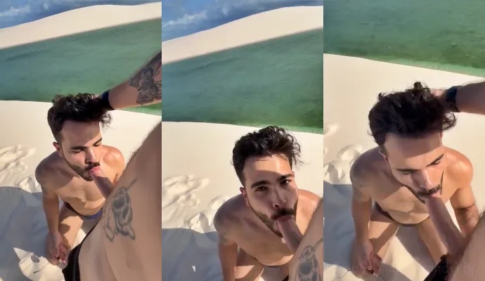 Two guys blow eachother at a public beach spot